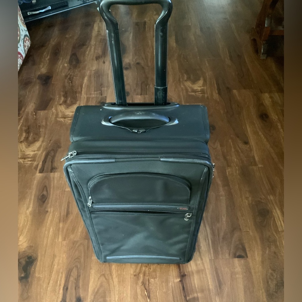TUMI alpha 2 Carry On 2 wheel Luggage with cosmetic defects pictured. Rolls good